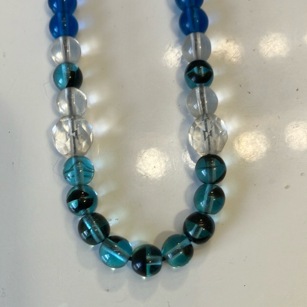 Glass beads with color swirls inside help make up this 20” Necklace.